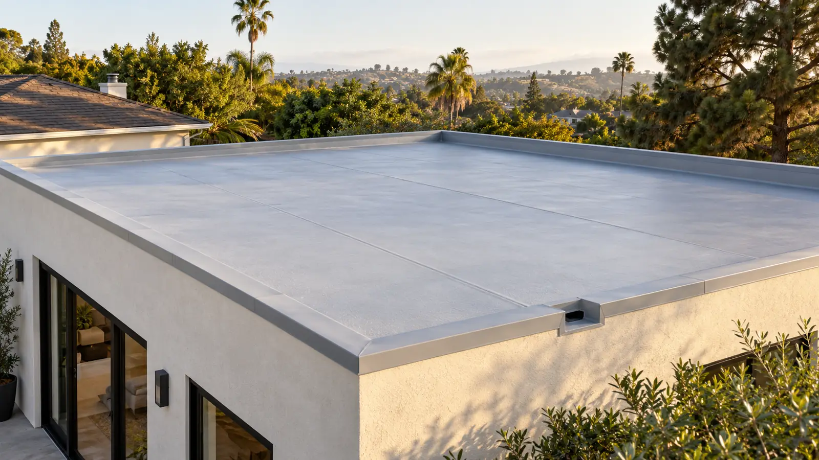 Illustration of a light gray low-slope membrane roof on a home addition